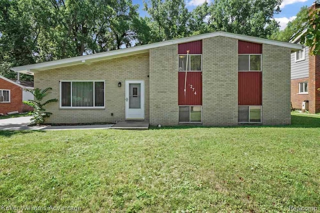 274 Beaver St, Brighton, MI 48116 - view of front of house with a front yard and brick siding