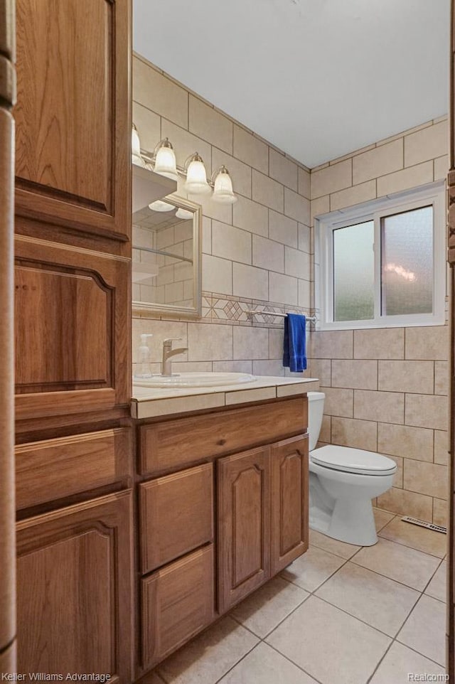 274 Beaver St, Brighton, MI 48116 - bathroom featuring tile patterned floors, vanity, tile walls, and decorative backsplash