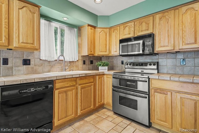 274 Beaver St, Brighton, MI 48116 - kitchen with black appliances, tile countertops, decorative backsplash, light brown cabinets, and recessed lighting
