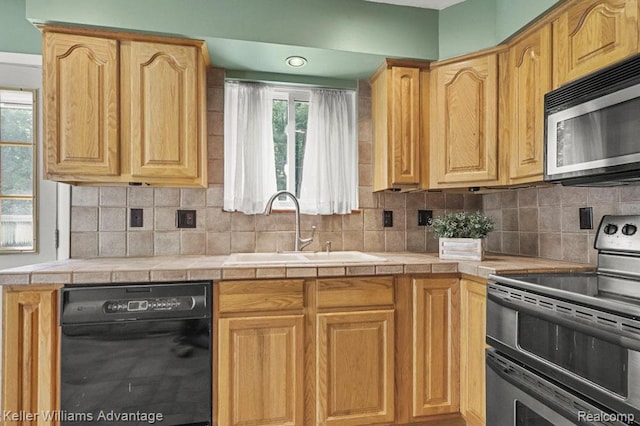 274 Beaver St, Brighton, MI 48116 - kitchen featuring stainless steel appliances, tile counters, backsplash, and light brown cabinetry