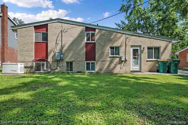 274 Beaver St, Brighton, MI 48116 - rear view of property featuring a lawn and brick siding