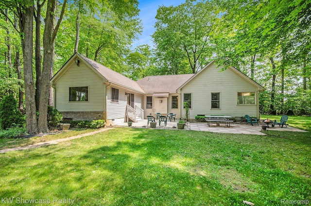 3675 S Commerce Rd, Commerce Twp, MI 48390 - back of property featuring a patio area, a fire pit, entry steps, a lawn, and roof with shingles