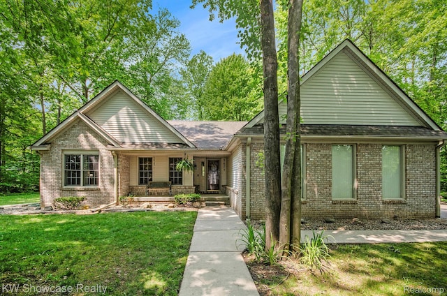 3675 S Commerce Rd, Commerce Twp, MI 48390 - ranch-style home with covered porch, brick siding, and a front lawn