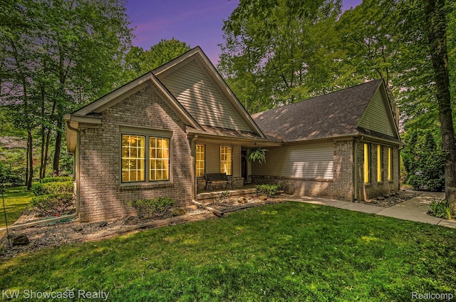 3675 S Commerce Rd, Commerce Twp, MI 48390 - view of front of home with a front yard, brick siding, a porch, and a shingled roof