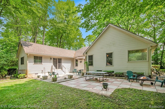 3675 S Commerce Rd, Commerce Twp, MI 48390 - rear view of property with entry steps, a lawn, an outdoor fire pit, and a patio