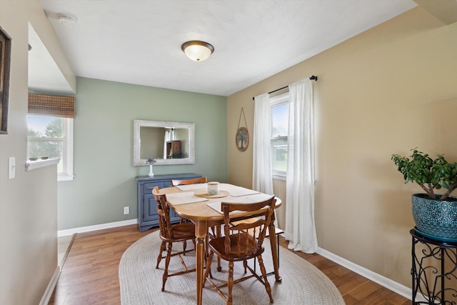 12350 S Butternut Ave, Sand Lake, MI 49343 - dining room featuring plenty of natural light and wood finished floors