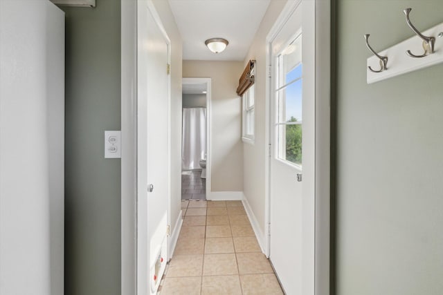 12350 S Butternut Ave, Sand Lake, MI 49343 - corridor with light tile patterned floors and baseboards