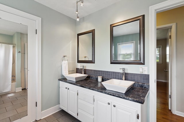 12350 S Butternut Ave, Sand Lake, MI 49343 - full bath with double vanity, curtained shower, and decorative backsplash