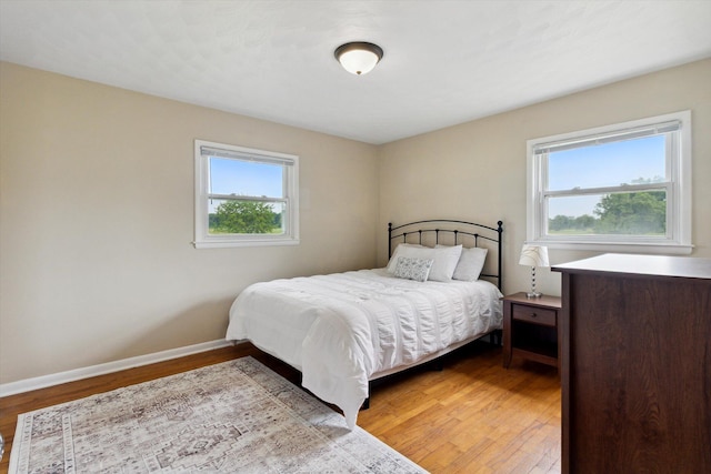 12350 S Butternut Ave, Sand Lake, MI 49343 - bedroom featuring wood finished floors