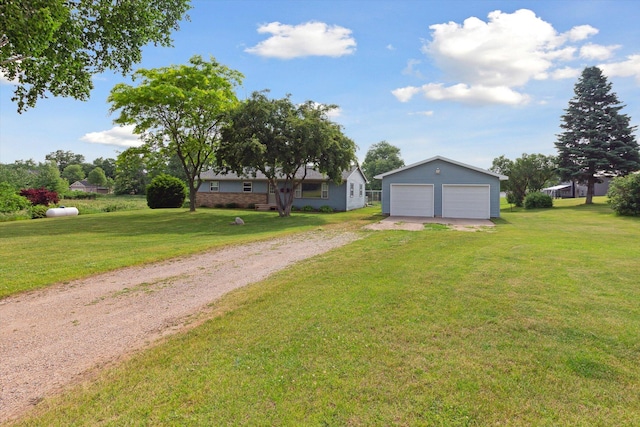 12350 S Butternut Ave, Sand Lake, MI 49343 - view of green lawn with an outbuilding, a garage, and driveway