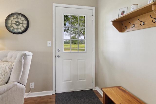 12350 S Butternut Ave, Sand Lake, MI 49343 - doorway featuring dark wood-style floors and baseboards