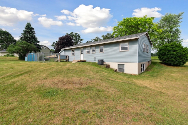12350 S Butternut Ave, Sand Lake, MI 49343 - rear view of property with a lawn and a storage unit