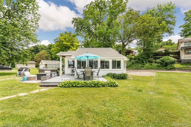 11729 Algonquin Dr, Pinckney, MI 48169 - rear view of property featuring a yard, a patio area, and roof with shingles