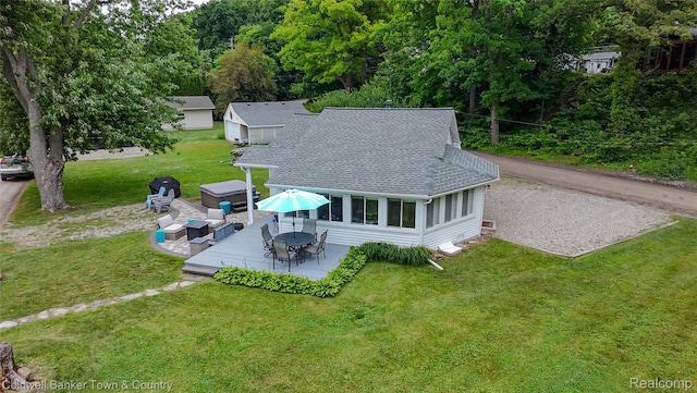 11729 Algonquin Dr, Pinckney, MI 48169 - rear view of house featuring roof with shingles, a lawn, a sunroom, outdoor dining area, and outdoor lounge area