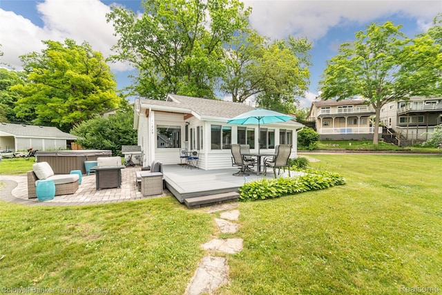 11729 Algonquin Dr, Pinckney, MI 48169 - back of property featuring a hot tub, a wooden deck, a lawn, and roof with shingles