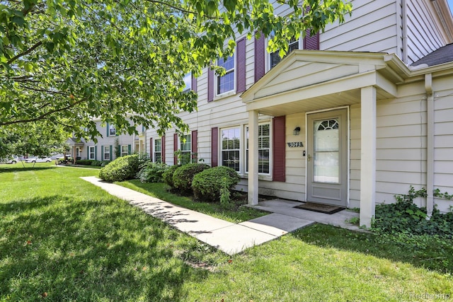 3043 Oakridge Ct, Lake Orion, MI 48360 - view of exterior entry with a lawn
