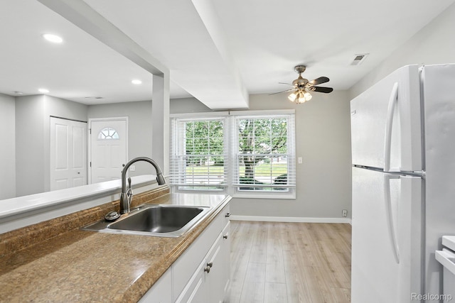 3043 Oakridge Ct, Lake Orion, MI 48360 - kitchen featuring freestanding refrigerator, white cabinetry, light wood finished floors, a ceiling fan, and recessed lighting