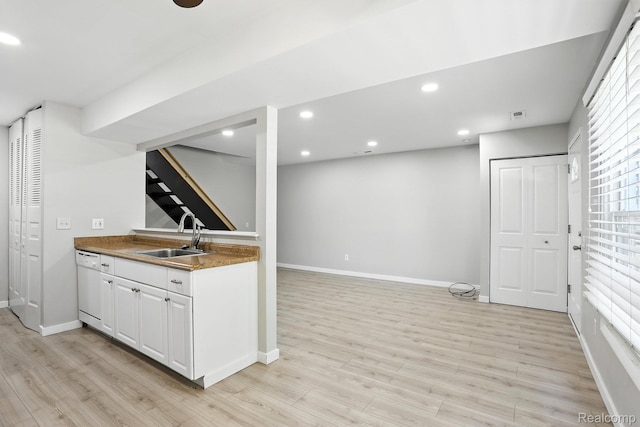 3043 Oakridge Ct, Lake Orion, MI 48360 - bar area featuring white dishwasher, light wood-style flooring, stairway, and recessed lighting