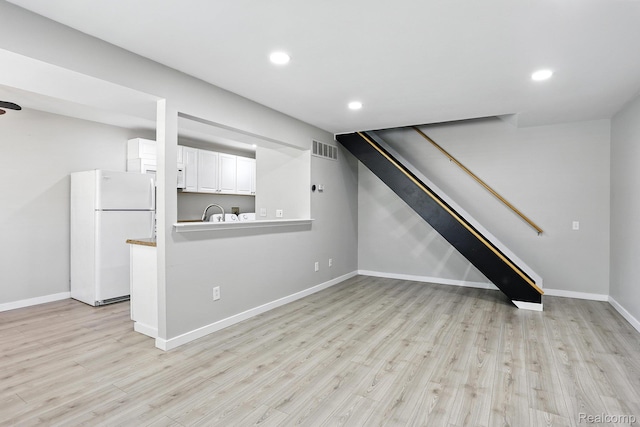 3043 Oakridge Ct, Lake Orion, MI 48360 - unfurnished living room featuring light wood-type flooring, recessed lighting, and stairs