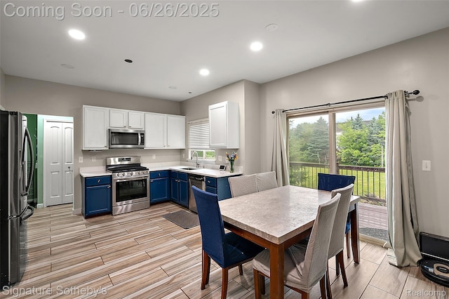 2155 Canal St, Commerce Twp, MI 48382 - kitchen featuring blue cabinets, stainless steel appliances, white cabinetry, light countertops, and recessed lighting
