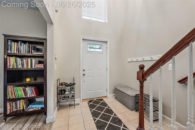 2155 Canal St, Commerce Twp, MI 48382 - entrance foyer featuring light tile patterned flooring, stairs, and a high ceiling