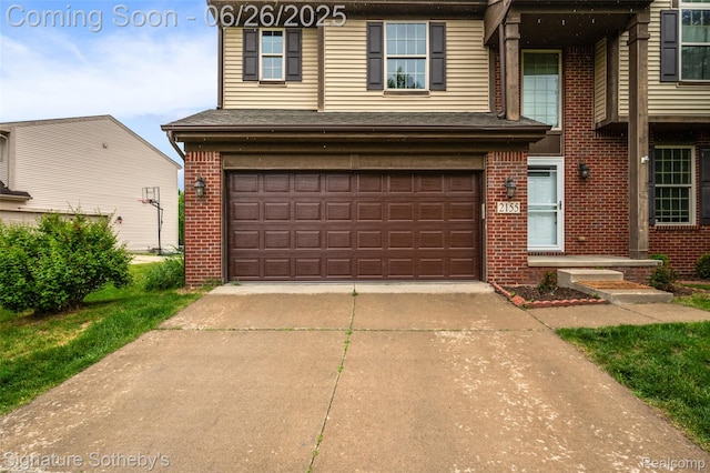 2155 Canal St, Commerce Twp, MI 48382 - view of front of house with brick siding, driveway, and a garage