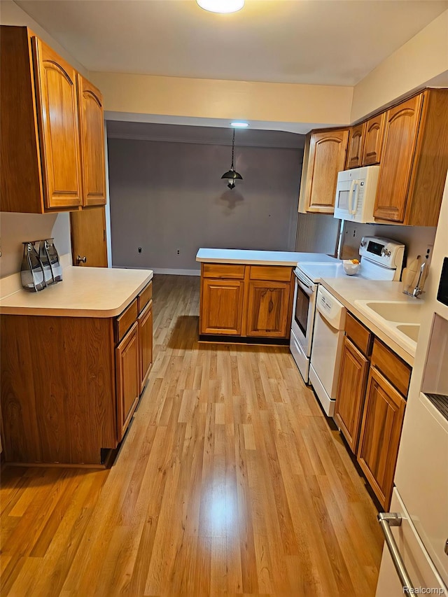 3976 Bristol Dr, Troy, MI 48083 - kitchen with white appliances, brown cabinetry, and a peninsula
