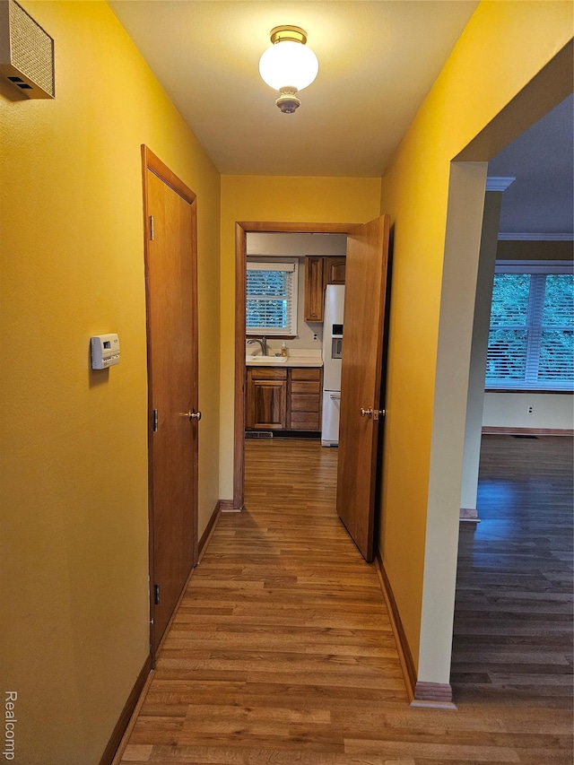 3976 Bristol Dr, Troy, MI 48083 - corridor with a sink and wood finished floors