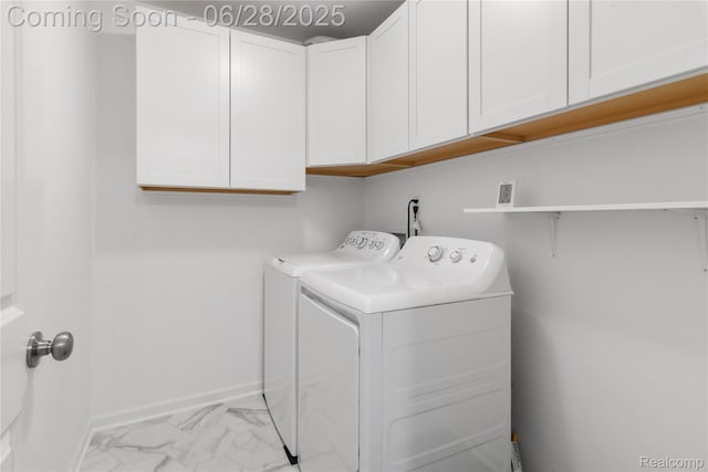 10001 Swan Lake Cir, Ypsilanti, MI 48197 - laundry room featuring washing machine and dryer, cabinet space, and light marble finish flooring