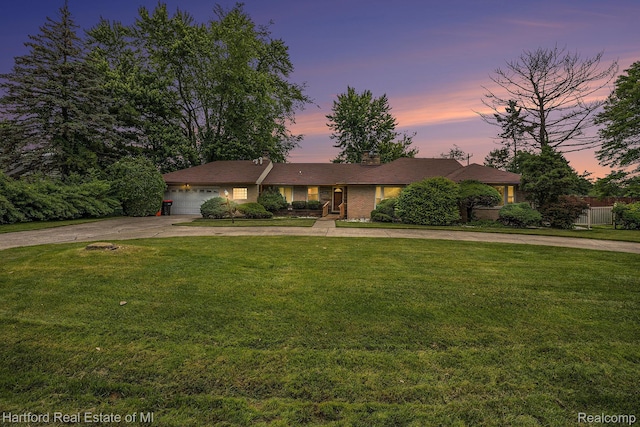 19100 Coral Gables St, Southfield, MI 48076 - ranch-style house with curved driveway, an attached garage, a lawn, and a chimney