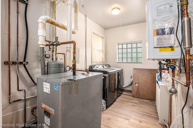 19100 Coral Gables St, Southfield, MI 48076 - laundry room with washing machine and clothes dryer, wood finished floors, and a heating unit