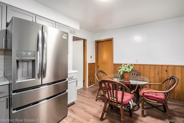 19100 Coral Gables St, Southfield, MI 48076 - dining room with a wainscoted wall, light wood-style floors, and wooden walls