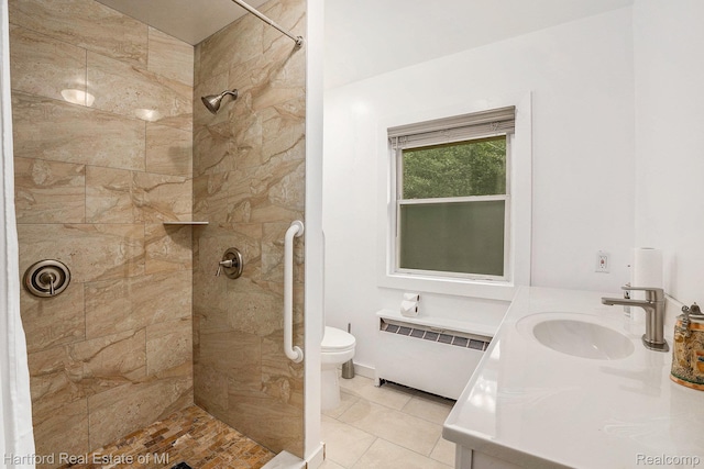 19100 Coral Gables St, Southfield, MI 48076 - bathroom featuring radiator heating unit, a tile shower, vanity, and tile patterned floors