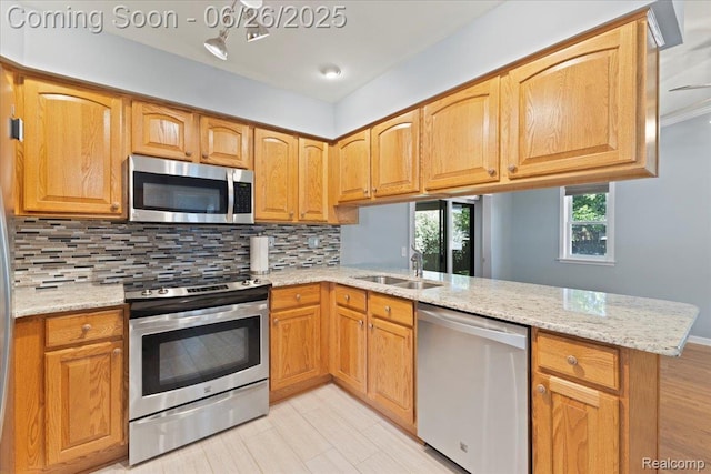 41615 Westmeath Cir, Clinton Township, MI 48038 - kitchen featuring stainless steel appliances, a peninsula, backsplash, and light stone countertops
