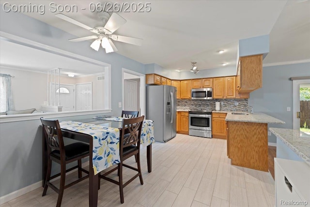 41615 Westmeath Cir, Clinton Township, MI 48038 - kitchen with stainless steel appliances, decorative backsplash, a ceiling fan, light stone countertops, and light wood-style flooring