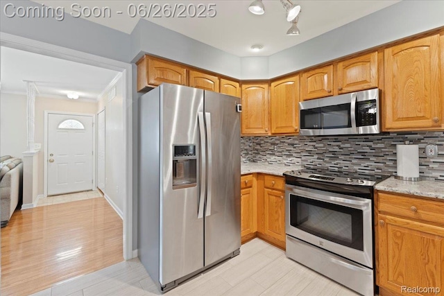 41615 Westmeath Cir, Clinton Township, MI 48038 - kitchen featuring stainless steel appliances, backsplash, light stone counters, and brown cabinetry