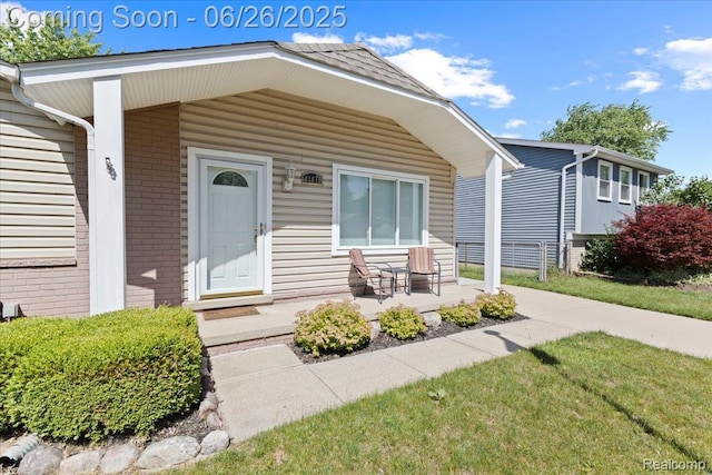 41615 Westmeath Cir, Clinton Township, MI 48038 - view of front facade featuring covered porch, brick siding, and a front lawn