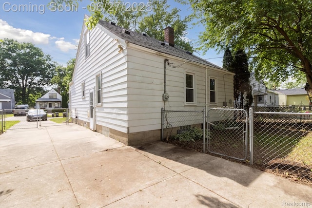 15848 Woodworth, Plymouth, MI 48239 - view of front facade with a gate, a chimney, driveway, and roof with shingles