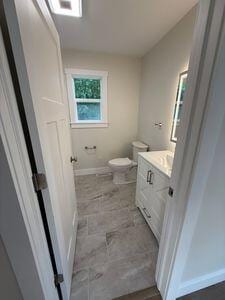 817 Sandow Rd, Midland, MI 48640 - bathroom featuring vanity and toilet