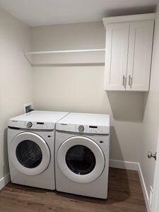 817 Sandow Rd, Midland, MI 48640 - laundry area featuring cabinet space, washer and clothes dryer, and dark wood finished floors