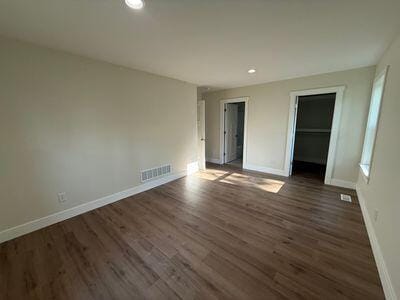 817 Sandow Rd, Midland, MI 48640 - unfurnished bedroom featuring wood finished floors, recessed lighting, and a closet