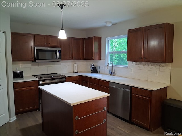 155 Cascade Ln, Waterford, MI 48327 - kitchen with appliances with stainless steel finishes, wood finished floors, decorative backsplash, and light countertops