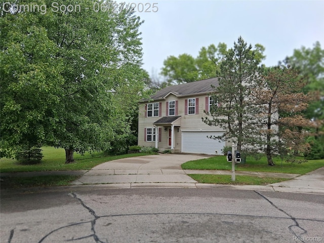 155 Cascade Ln, Waterford, MI 48327 - traditional-style home featuring concrete driveway, a garage, and a front lawn