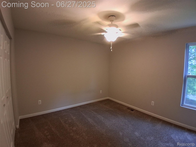 155 Cascade Ln, Waterford, MI 48327 - unfurnished room with dark carpet, a ceiling fan, and a textured ceiling