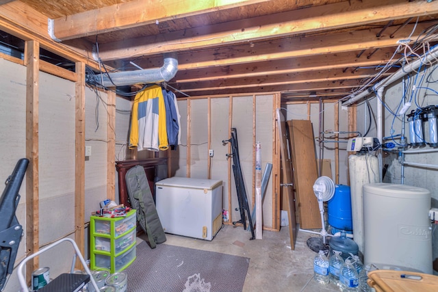 123 Carlysle Dr, Brooklyn, MI 49230 - unfinished basement with white fridge, a water pressure tank, and a water softener system