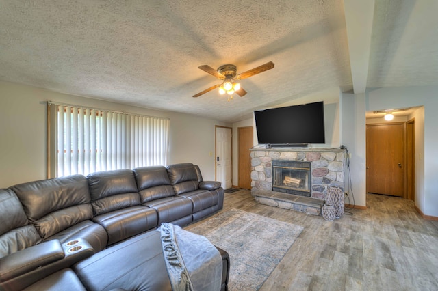 123 Carlysle Dr, Brooklyn, MI 49230 - living room with a ceiling fan, wood finished floors, a fireplace, and a textured ceiling