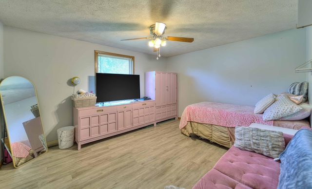 123 Carlysle Dr, Brooklyn, MI 49230 - bedroom with light wood-style flooring, a textured ceiling, and ceiling fan