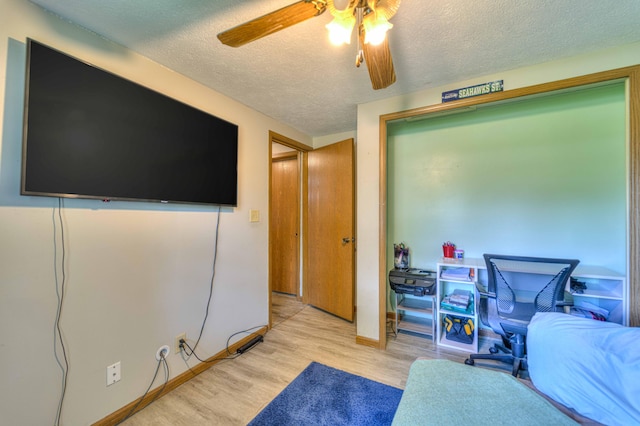 123 Carlysle Dr, Brooklyn, MI 49230 - bedroom with a textured ceiling, light wood-type flooring, and a ceiling fan