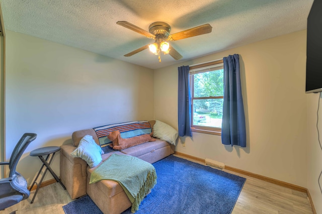 123 Carlysle Dr, Brooklyn, MI 49230 - living area with wood finished floors, a ceiling fan, and a textured ceiling