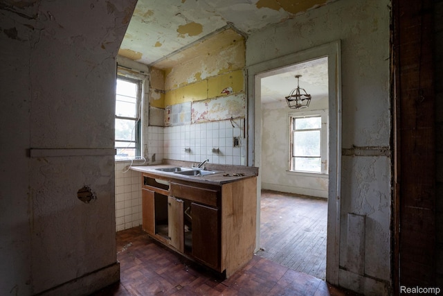 16665 Tuller St, Detroit, MI 48221 - kitchen with healthy amount of natural light, brown cabinetry, dark wood-style flooring, and a chandelier